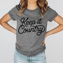 Load image into Gallery viewer, Person wearing a gray t-shirt with 'Keep it Country' text on a plain background