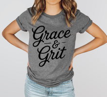 Load image into Gallery viewer, Person wearing a gray t-shirt with 'Grace &amp; Grit' text on a plain background