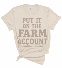 Load image into Gallery viewer, Beige t-shirt with 'Put it on the Farm Account' text on a white background