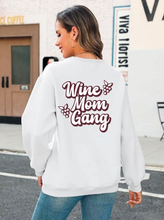 Load image into Gallery viewer, Person wearing a white sweatshirt with 'Wine Mom Gang' text on the back, standing on a street.